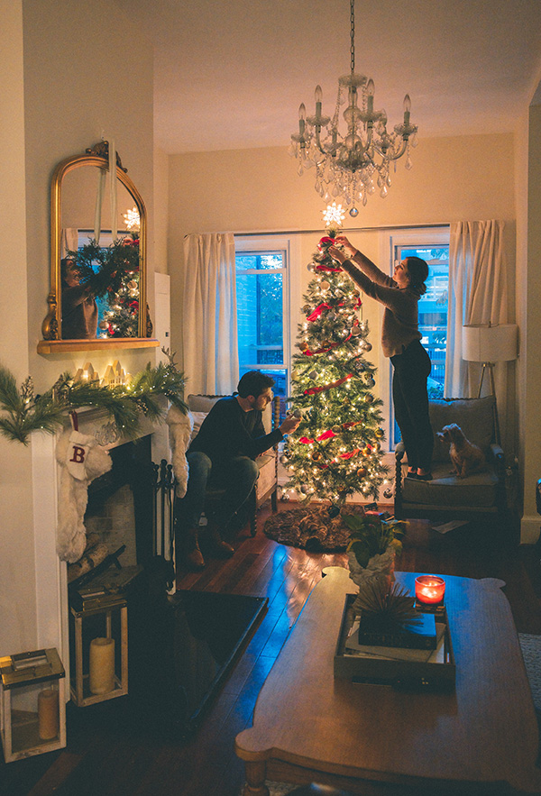Man and woman decorating Christmas tree