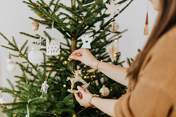 Woman decorating Christmas tree